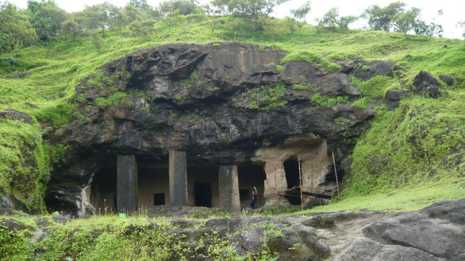 Ellora-style rock-cut sculptures depicting Lord Shiva in various forms, including the iconic 20-foot Trimurti statue, inside the ancient Elephanta Caves on Elephanta Island near Mumbai, India.